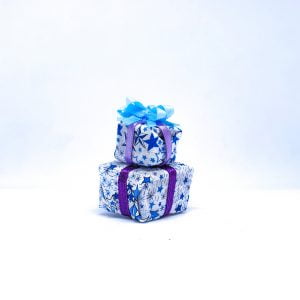 Handmade miniature present stack complete with bow